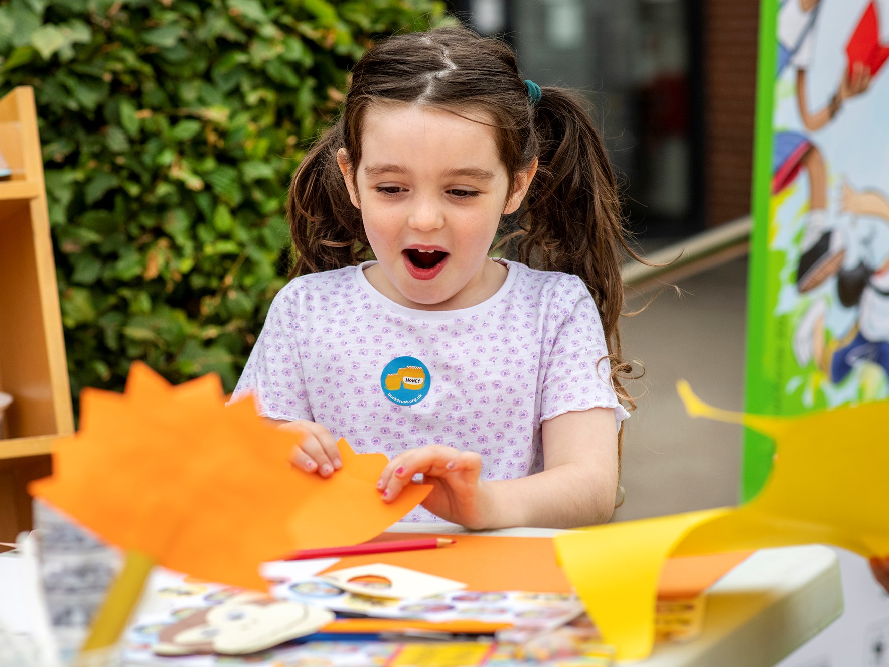 An excited young girl, crafting.