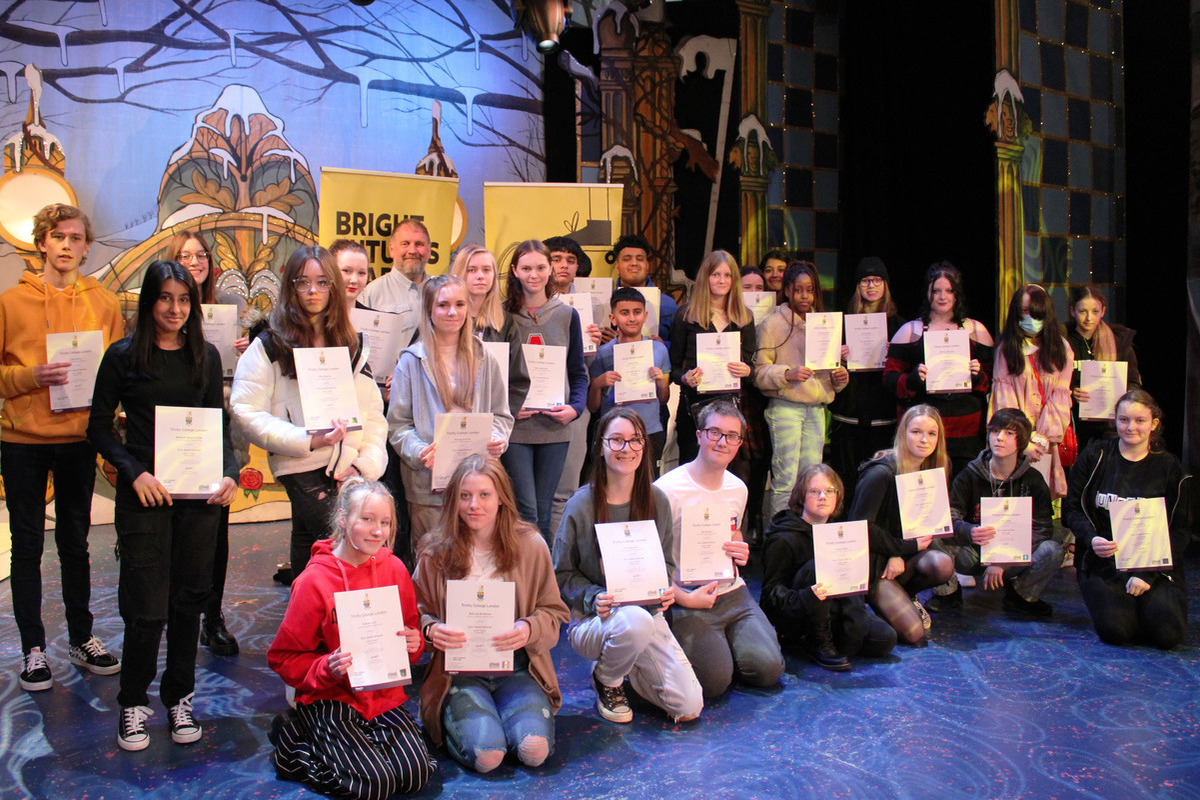 People holding their arts award certificates.