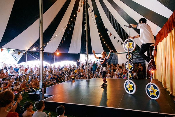 Acrobatic performs in front of a busy crowd.