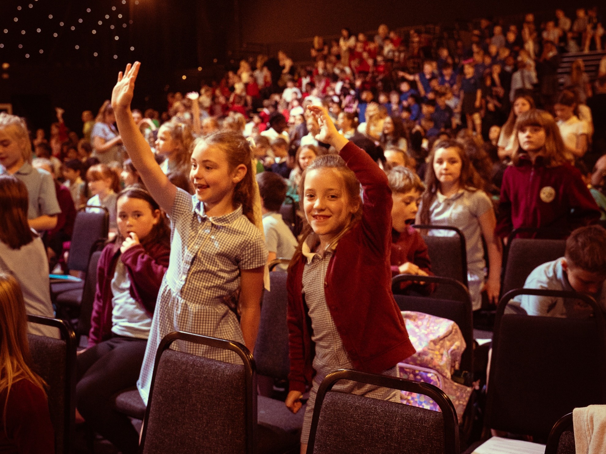 A large number of children cheering