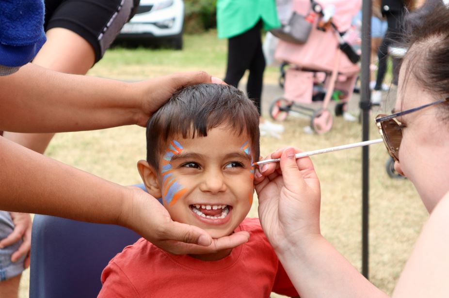 A child having their face painted