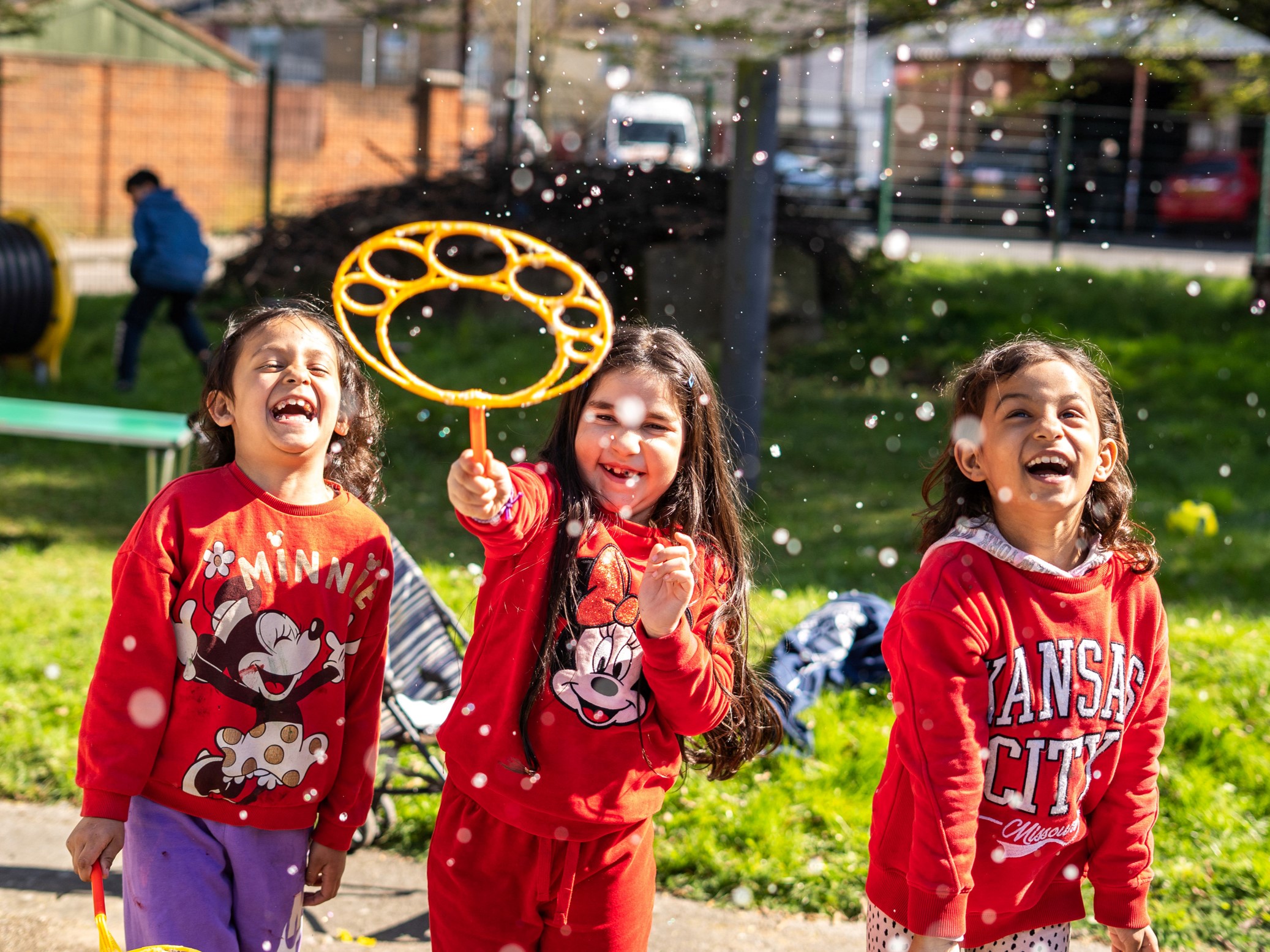 3 young girls smile for the camera.