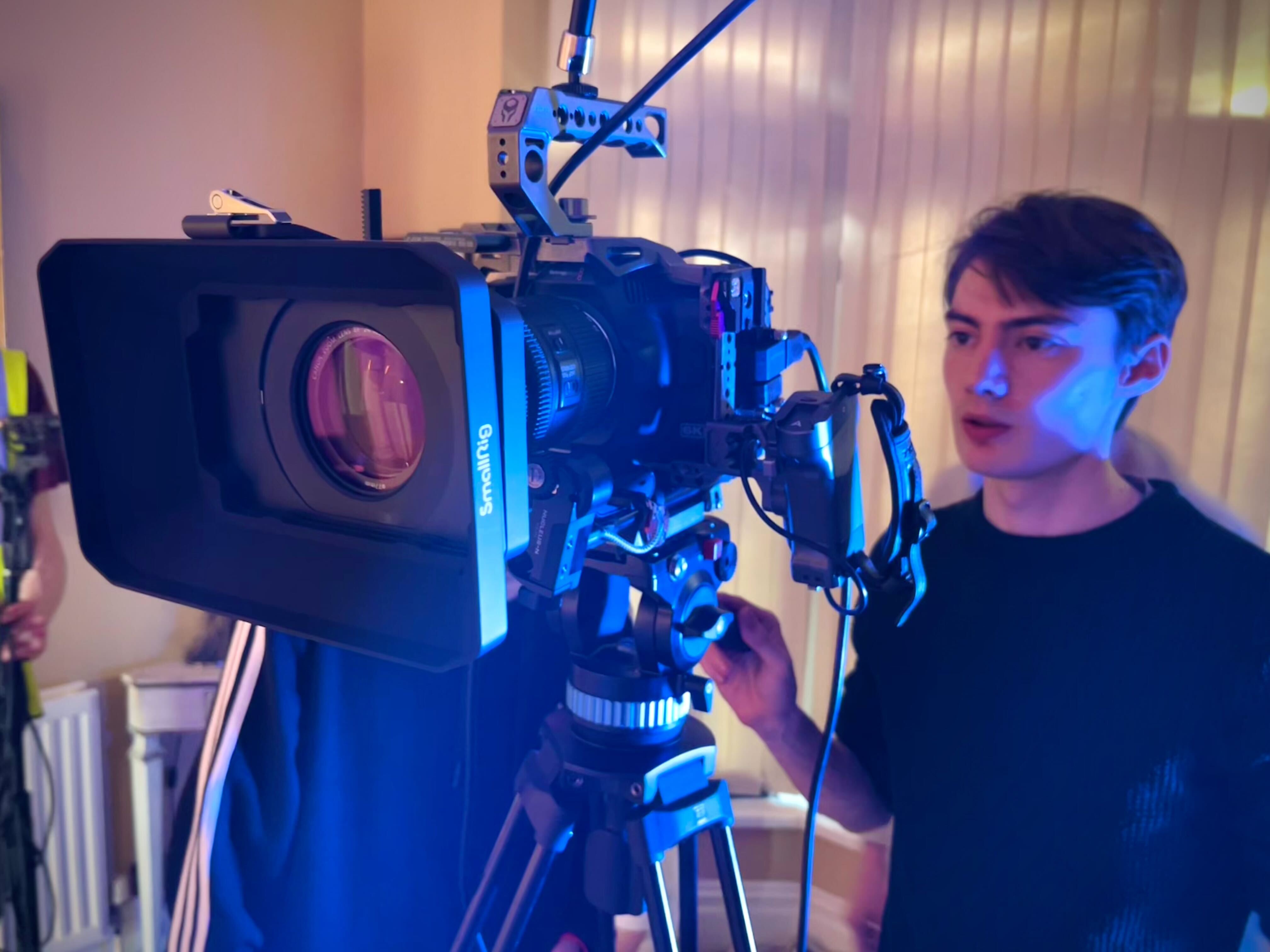 Someone stood behind a camera
