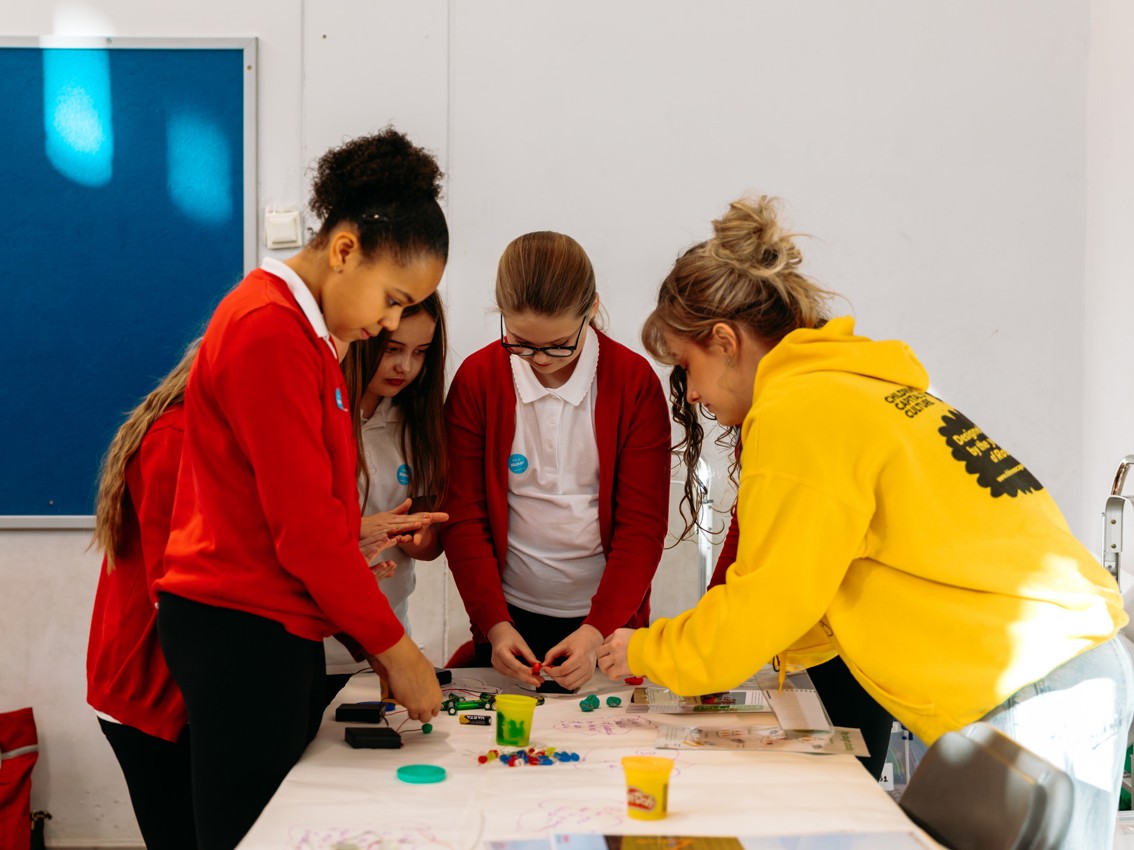 Three people making something
