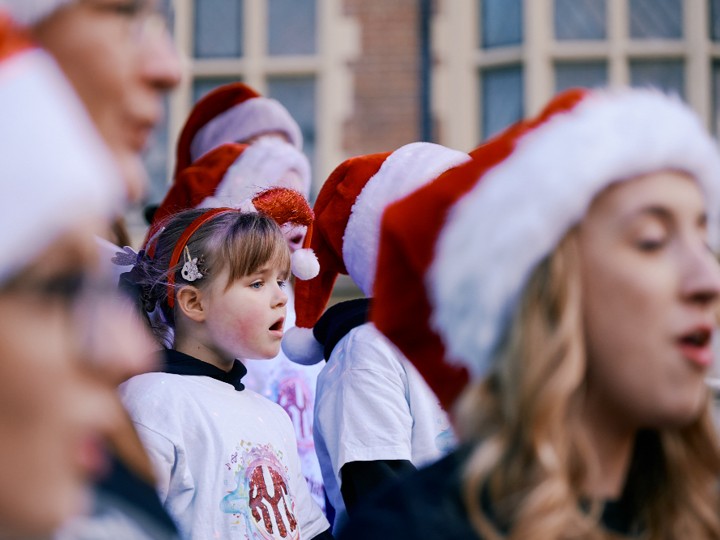 People in a crowd earing Santa hats