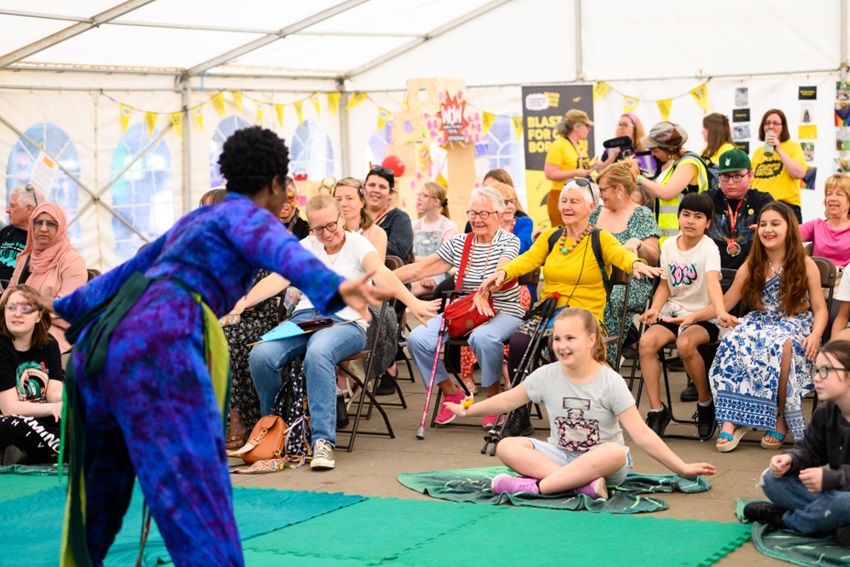 Someone performing in front of a crowd at the WOW festival.