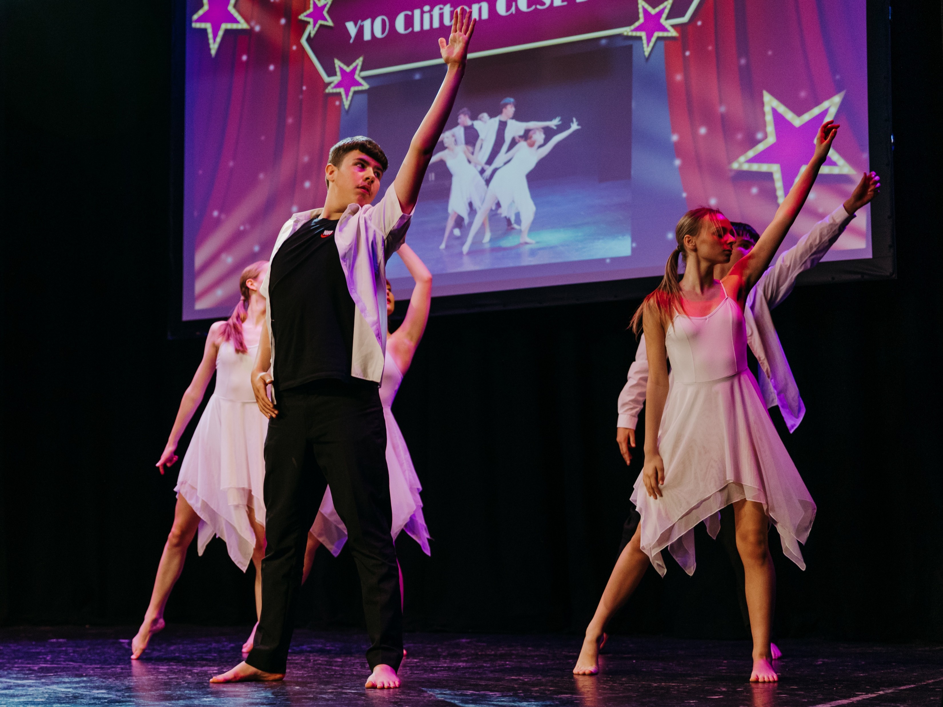 People perform a dance routine on stage